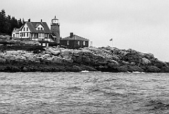 Whitehead Lighthouse on Rocky Shoreline on a Cloudy Day in Maine